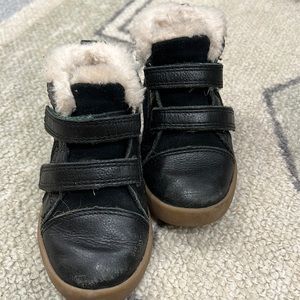 Ugg Rennon II boots in black with green soles.